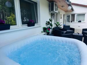 a hot tub on the patio of a house at Juicy Private Apartments with Jacuzzi in Szentendre