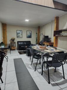 a living room with a table and chairs at Sítio Casa Verde in Uruguaiana
