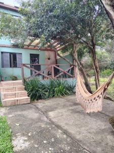 a hammock in front of a house at Sítio Casa Verde in Uruguaiana