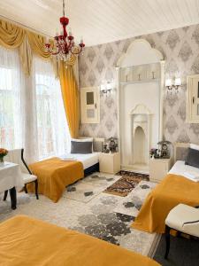 a bedroom with two beds and a fireplace at Sheki Panorama Garden in Sheki