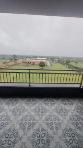 a room with a balcony with a view of a field at Pride Resort Jodhpur in Banār