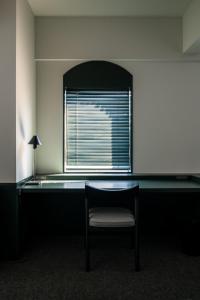 a room with a table and a chair and a window at DDD HOTEL in Tokyo +63 photos