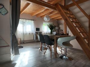 a dining room with a table and some chairs at MorsoChatki - balia, sauna, garden party, plaża in Jelenia Góra