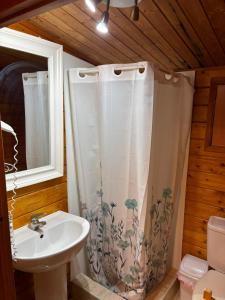 a bathroom with a sink and a shower curtain at Camping Torremolinos in Torremolinos +37 photos
