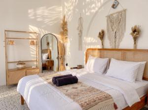 a bedroom with a large bed with a large mirror at Hanara Bohemian Villa in Bandung