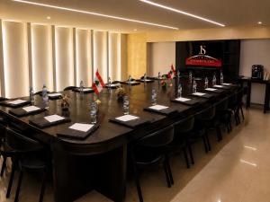 a long table in a room with chairs and flags at Jounieh Suites Boutique Hotel in Jounieh +103 photos