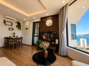 a living room with a table and a large window at 2-3 bedroom at HUD building Nha Trang in Nha Trang
