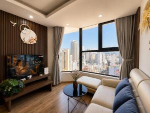 a living room with a couch and a large window at 2-3 bedroom at HUD building Nha Trang in Nha Trang