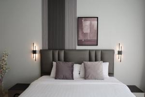 a bedroom with a large bed with white sheets and pillows at Sunny Beach Residence in Jomtien Beach +16 photos