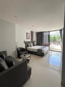 a bedroom with a bed and a living room at Sunny Beach Residence in Jomtien Beach