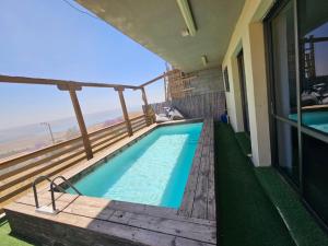 a swimming pool on the balcony of a house at Kinneret view with pool in Safed