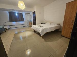 a bedroom with a bed and a couch and a window at Kinneret view with pool in Safed