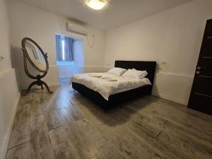 a bedroom with a bed with a mirror and a dresser at Kinneret view with pool in Safed