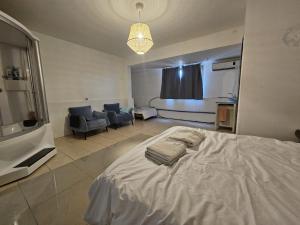 a bedroom with a bed and a living room at Kinneret view with pool in Safed +4 photos