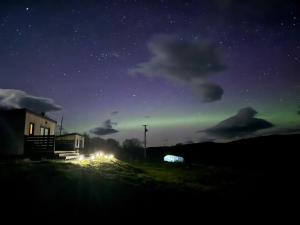 an image of the northern lights in the night sky at Croft Seven Cabins in Port na Long