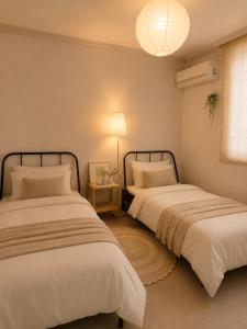 two beds sitting next to each other in a room at BLAU Korean Local Experience Stay in Gyeongju +31 photos