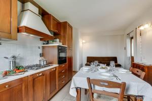 a kitchen with a table with a table cloth on it at Agriturismo Cascina Crocelle - Lake View and Heated Pool in Padenghe sul Garda