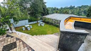 a house with a patio and a yard with a garden at Lotus villa lake resort in Matara