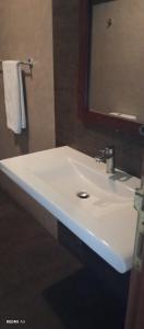 a bathroom with a white sink and a mirror at Lotus villa lake resort in Matara