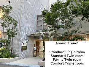 a building with a sign in front of it at Shin-Osaka Station Hotel in Osaka