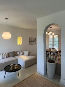 a living room with a couch and a table at Le Verger in Aix-en-Provence