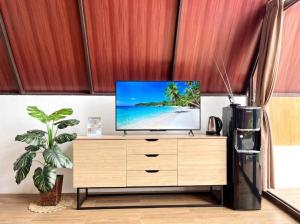 a television on a dresser in a living room at Heavenly 2 - Private Triangle in Bandung