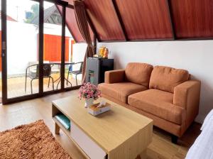 a living room with a couch and a table at Heavenly 2 - Private Triangle in Bandung