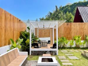 a backyard with a pergola with a fire pit at Heavenly 2 - Private Triangle in Bandung +2 photos