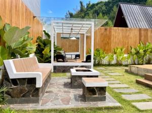 a patio with a bench and a table at Heavenly 2 - Private Triangle in Bandung