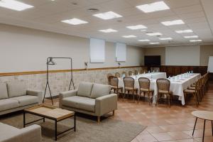 a room with a long table and chairs and a podium at Hotel Convento de Miranda in Miranda de Ebro