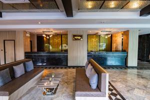 a lobby of a hotel with couches and a table at Kiss Gardenhome Chic Hotel in Hat Yai