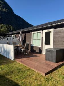 a deck with a table and chairs on a house at Gateway to Jotunheimen 4 Guests in Øvre Årdal