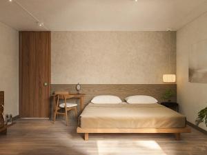 a bedroom with a bed and a table and a desk at Châu Home in Ninh Binh