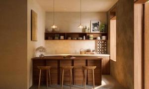 a kitchen with a bar with stools in it at Châu Home in Ninh Binh