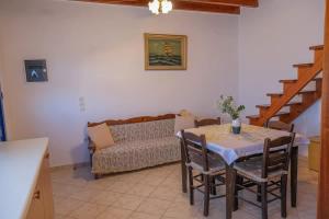 a dining room with a table and a couch at Breeze in Koumeika