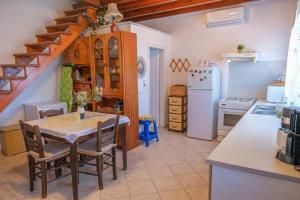 a kitchen with a table and a kitchen with a staircase at Breeze in Koumeika