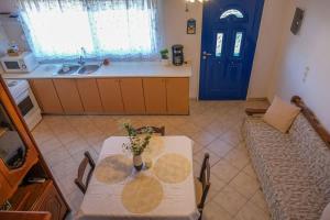 a living room with a table and a couch and a blue door at Breeze in Koumeika