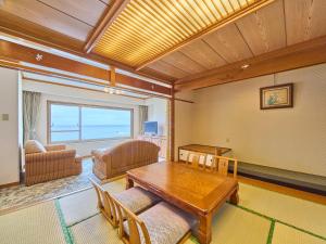 a living room with a table and a couch at Mikazuki Sea-Park Hotel Katsuura in Katsuura