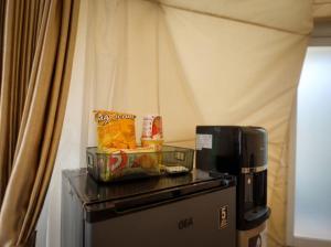 a coffee maker and snacks on top of a refrigerator at Himalaya 1 - Private Dome in Panjadakan