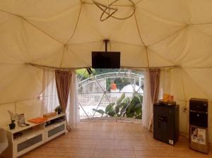 a large tent with a tv in the middle at Himalaya 1 - Private Dome in Panjadakan
