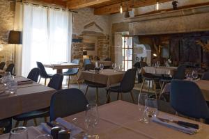 a restaurant with tables and chairs in a room at Villla DUO in Besançon