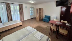 a room with a bed and a desk and a table at Penzion Rondo in Bystřice pod Hostýnem +58 photos