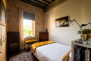 a bedroom with a bed and a window at "la suite" in Talant