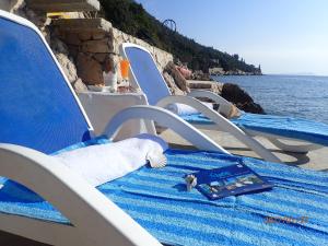a book is sitting on a blue blanket on a chair at Apartment Villa Bonadea in Slano