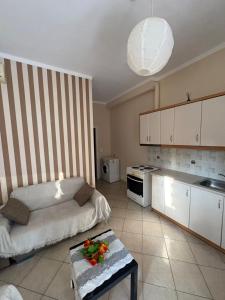 a kitchen with a bed and a table with flowers on it at Διαμερισμα στο Αιγιο in Aigio