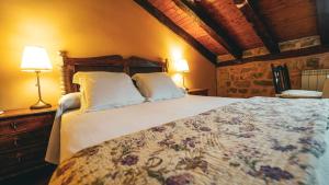 a bedroom with a large bed with two pillows at La Casona de Lucía in Sigüenza