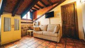 a living room with a couch and a door at La Casona de Lucía in Sigüenza