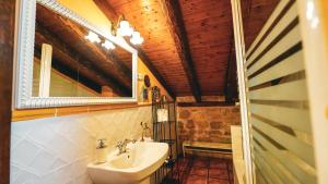 a bathroom with a sink and a mirror at La Casona de Lucía in Sigüenza +71 photos