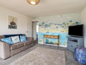 a living room with a couch and a flat screen tv at 38 St Margarets in Dover