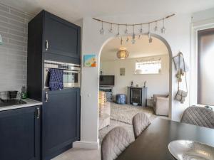 a kitchen with a blue cabinet and a table at 38 St Margarets in Dover